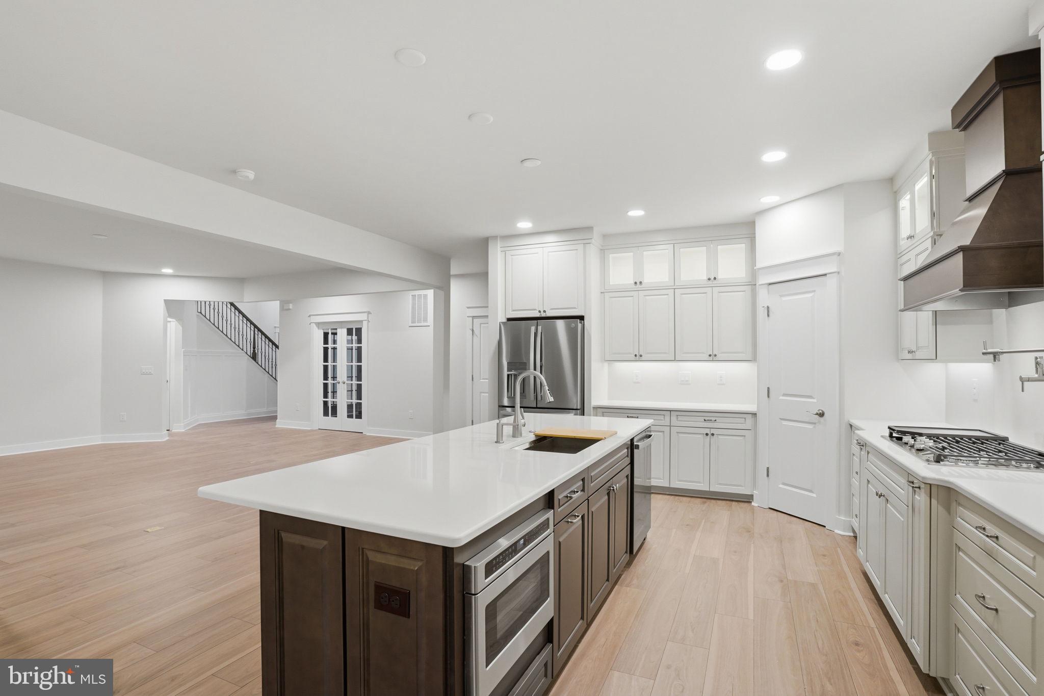 25015 Prairie Lane, Unit 3 Millsboro, DE 19966 - Photo 17 of 42 a kitchen with kitchen island a sink stove and refrigerator