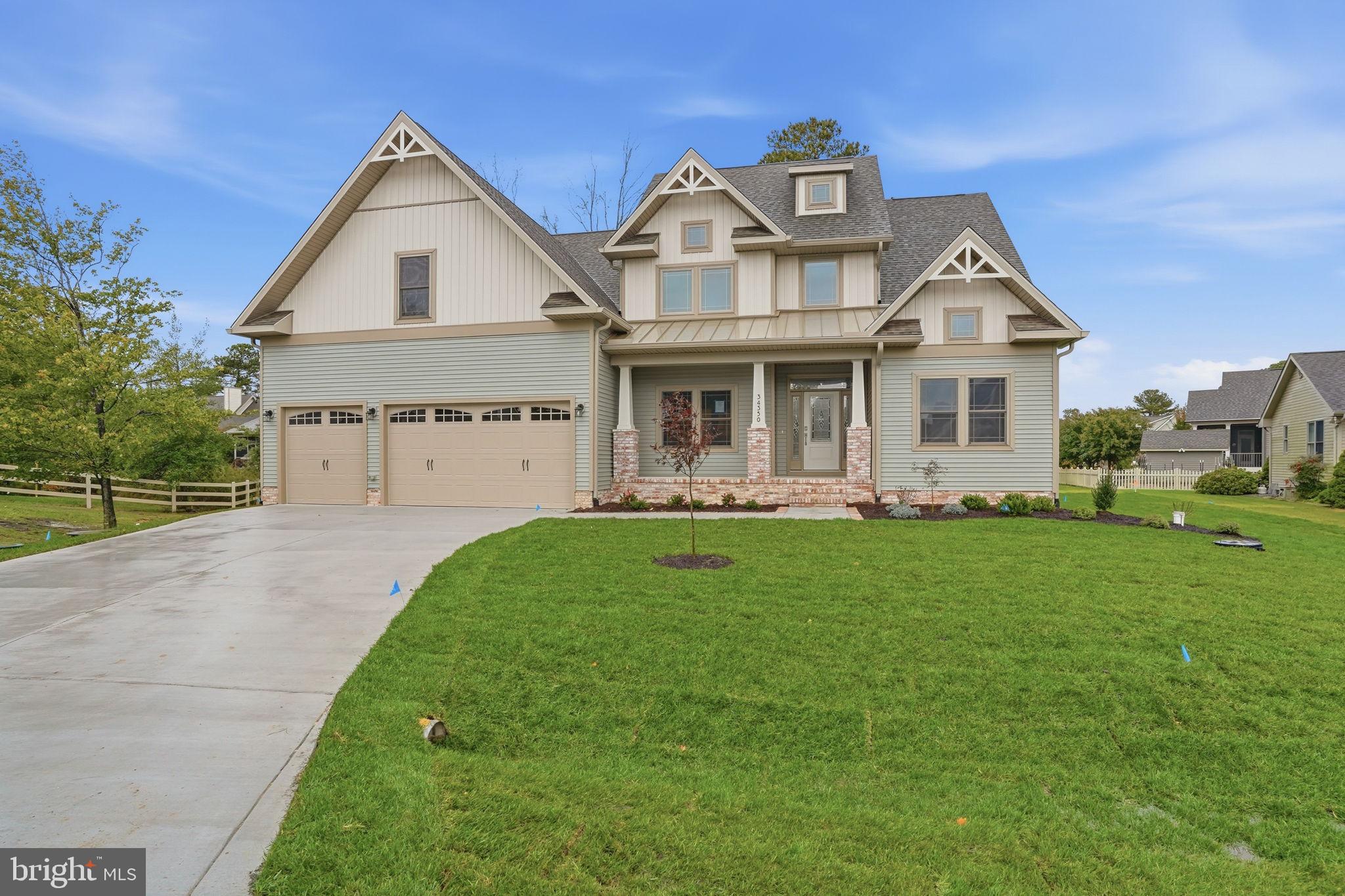 25015 Prairie Lane, Unit 3 Millsboro, DE 19966 - Photo 2 of 42 a front view of a house with a yard and trees