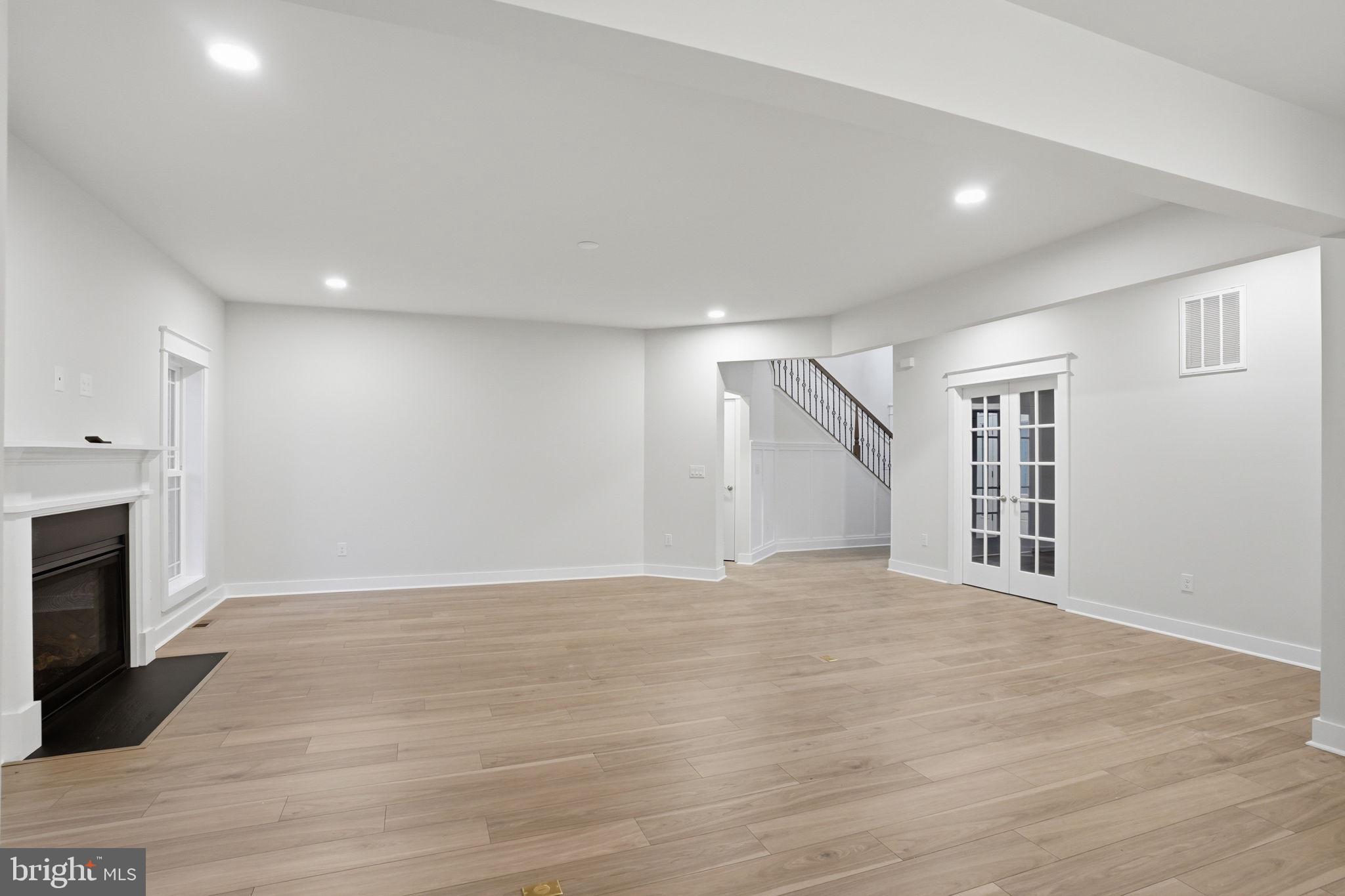 25015 Prairie Lane, Unit 3 Millsboro, DE 19966 - Photo 21 of 42 a view of an empty room with wooden floor fireplace and a window