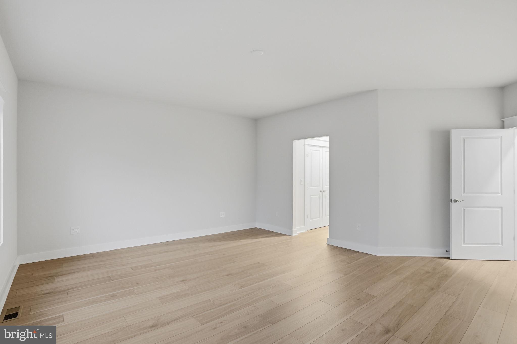 25015 Prairie Lane, Unit 3 Millsboro, DE 19966 - Photo 24 of 42 a view of an empty room and wooden floor