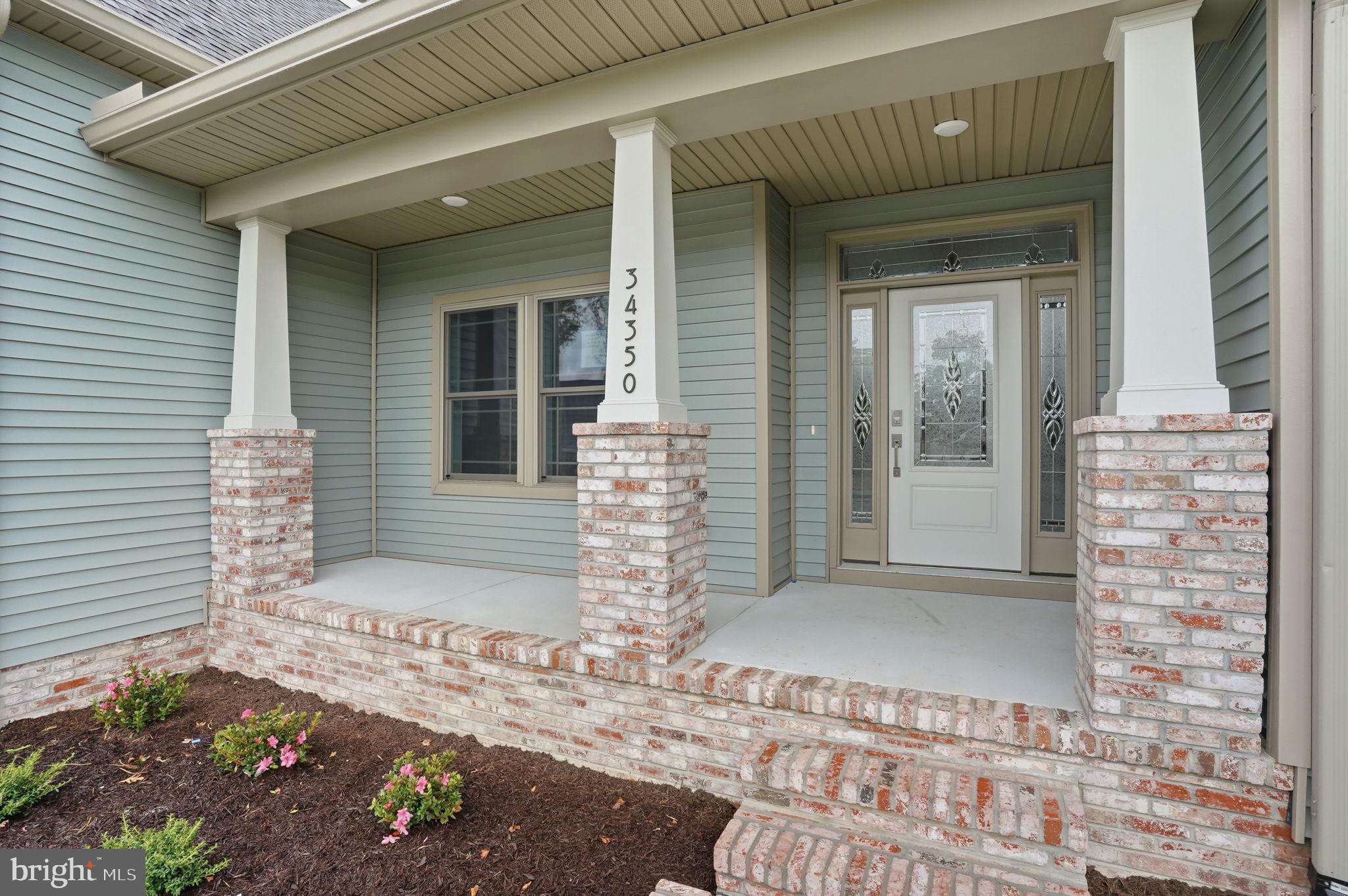 25015 Prairie Lane, Unit 3 Millsboro, DE 19966 - Photo 3 of 42 a front view of a house with a garage
