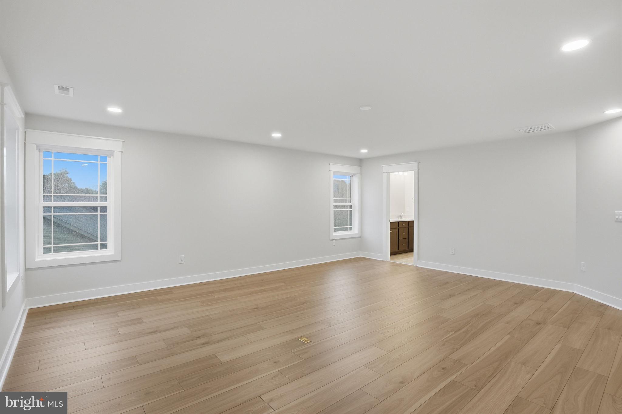 25015 Prairie Lane, Unit 3 Millsboro, DE 19966 - Photo 39 of 42 a view of an empty room with wooden floor and a window