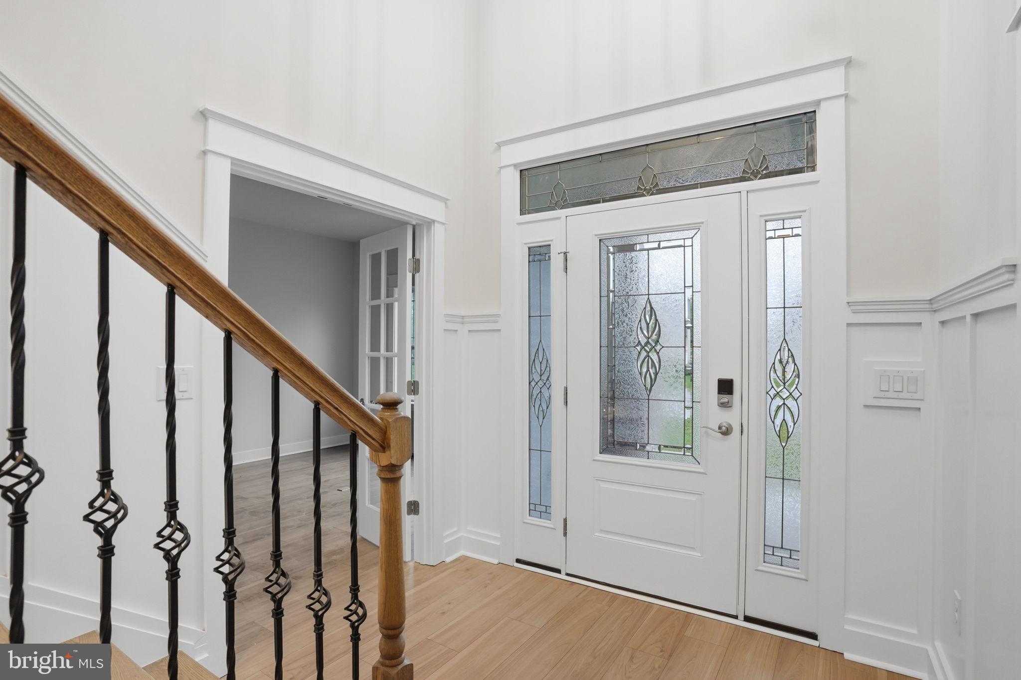 25015 Prairie Lane, Unit 3 Millsboro, DE 19966 - Photo 4 of 42 a view of an entryway with wooden floor and door