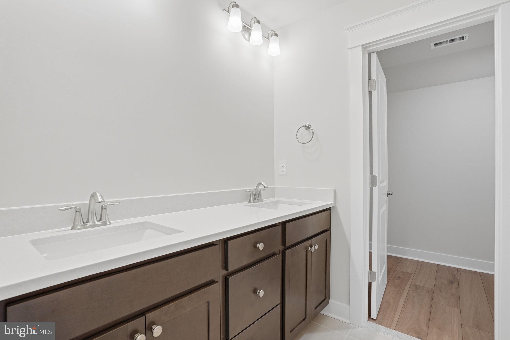 25015 Prairie Lane, Unit 3 Millsboro, DE 19966 - Photo 41 of 42 a bathroom with a sink and a mirror