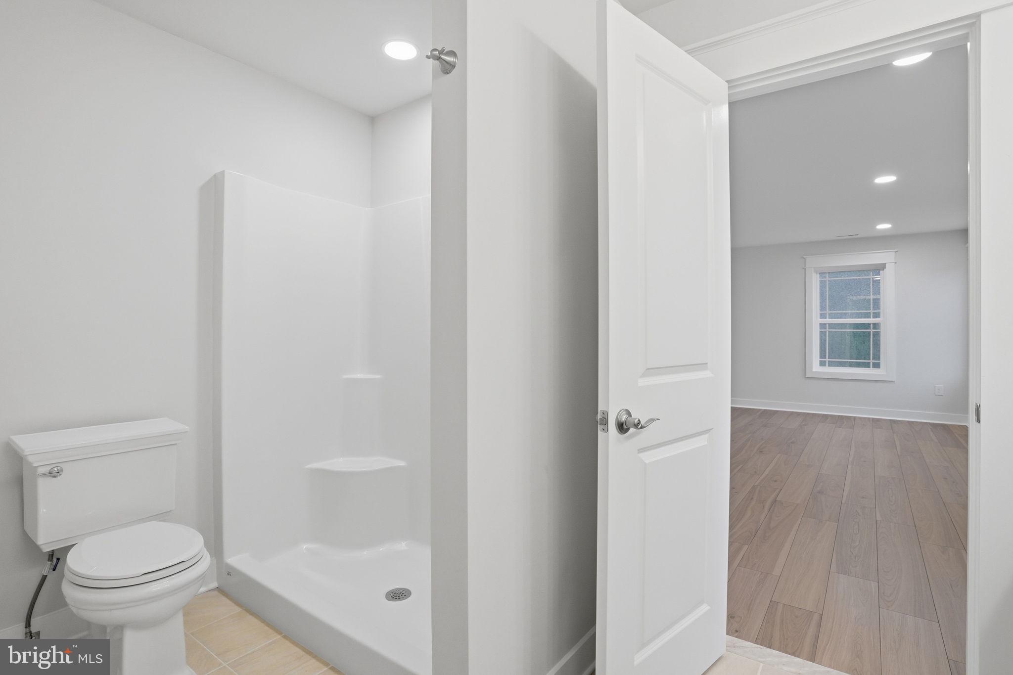 25015 Prairie Lane, Unit 3 Millsboro, DE 19966 - Photo 42 of 42 a bathroom with a toilet and a shower