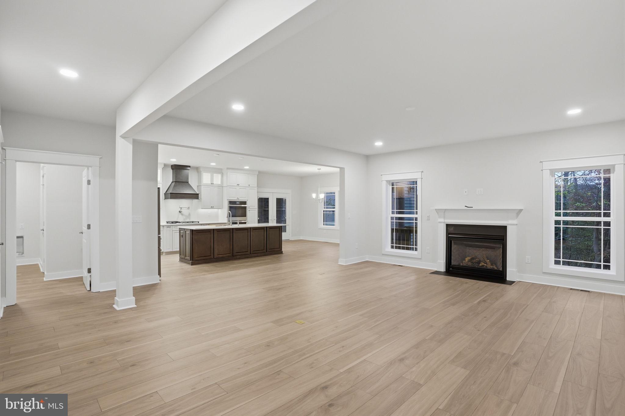 25015 Prairie Lane, Unit 3 Millsboro, DE 19966 - Photo 10 of 42 a view of a kitchen with a sink a fireplace and a window