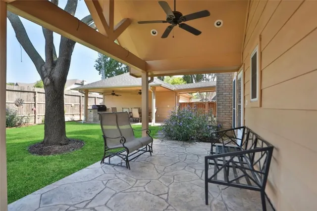 a view of patio with table and chairs and potted plants