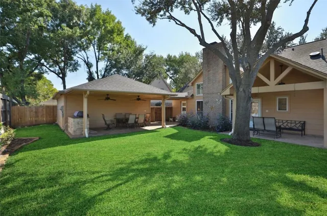 a view of a house with a yard and tree s