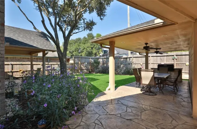 a view of a chair and table in backyard of the house
