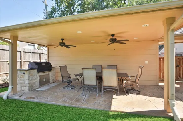 a view of a patio with table and chairs and potted plants