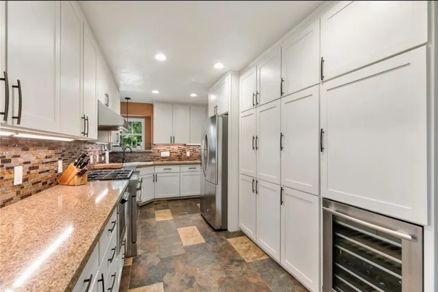 a kitchen with a refrigerator and a sink