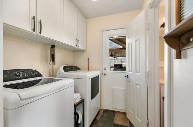a view of washer and dryer with kitchen in the background