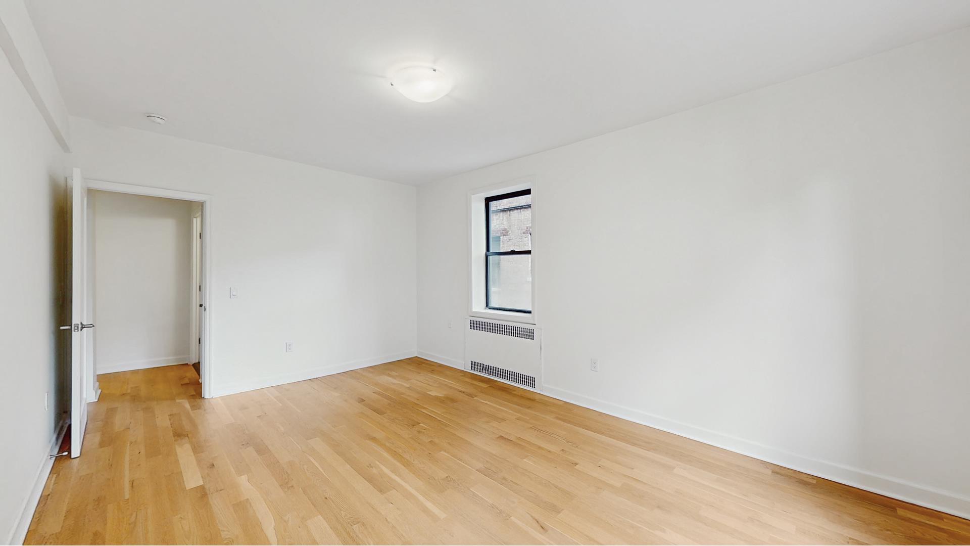 811 Cortelyou Road, Unit 1J Brooklyn, NY 11218 - Photo 10 of 15 a view of empty room with wooden floor