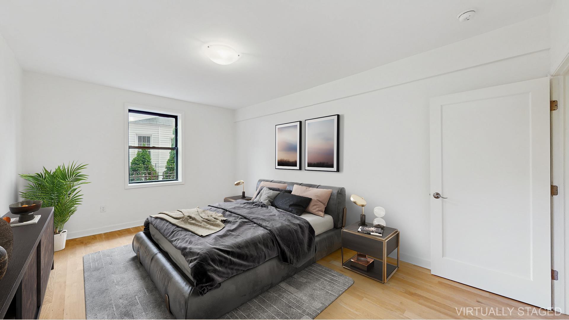 811 Cortelyou Road, Unit 1J Brooklyn, NY 11218 - Photo 2 of 15 a bedroom with a bed and a potted plant