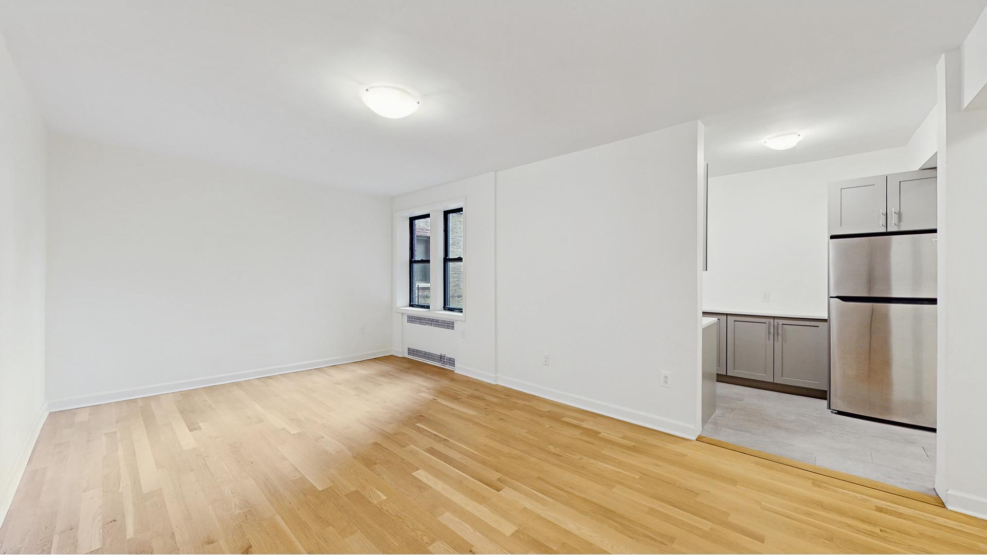 811 Cortelyou Road, Unit 1J Brooklyn, NY 11218 - Photo 3 of 15 a view of empty room with wooden floor and window