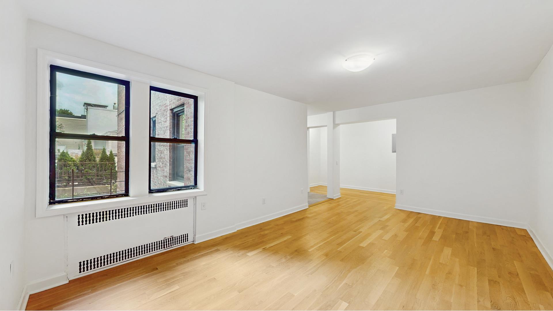 811 Cortelyou Road, Unit 1J Brooklyn, NY 11218 - Photo 5 of 15 a view of an empty room with a window