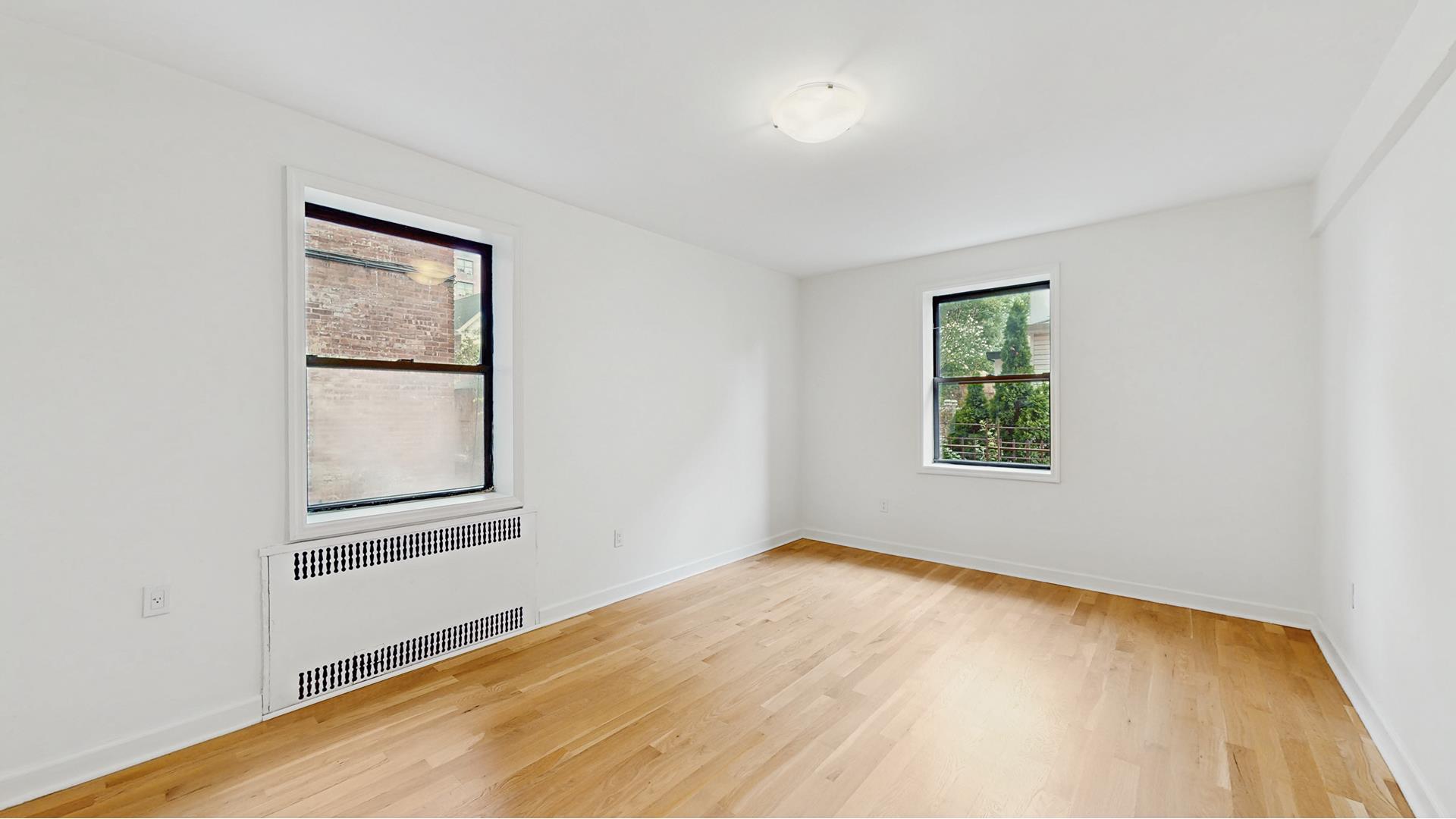 811 Cortelyou Road, Unit 1J Brooklyn, NY 11218 - Photo 8 of 15 an empty room with windows and closet