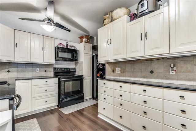 a kitchen with stainless steel appliances granite countertop a sink and cabinets