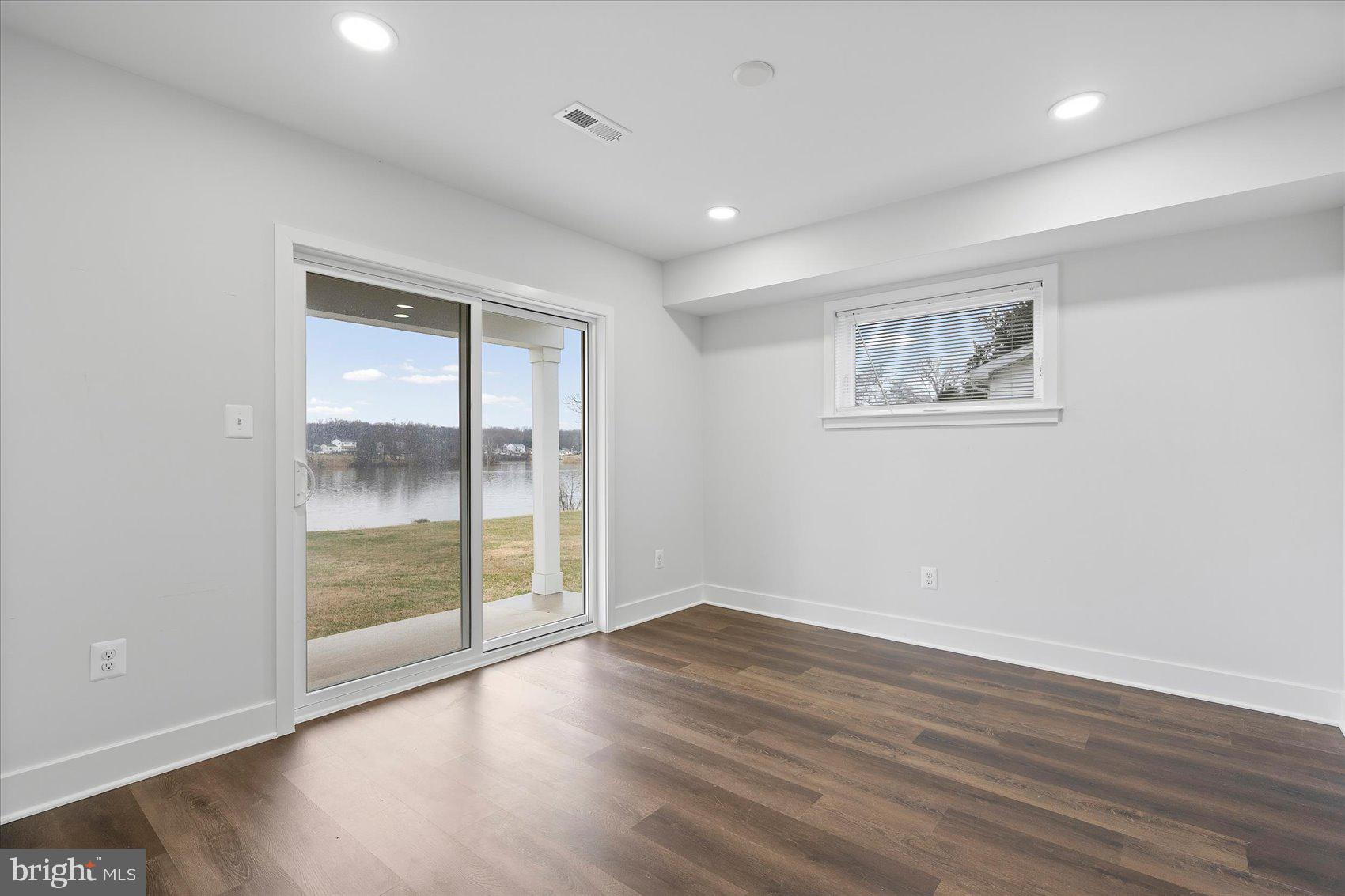 11030 Bird River Grove Road White Marsh, MD 21162 - Photo 12 of 53 an empty room with wooden floor and windows