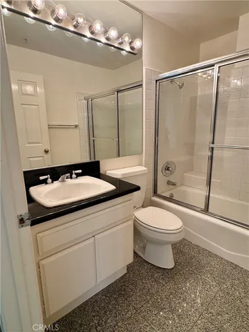a view of a kitchen with a sink and wooden floor