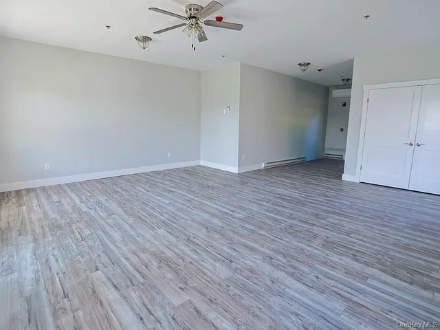 a view of an empty room and wooden floor