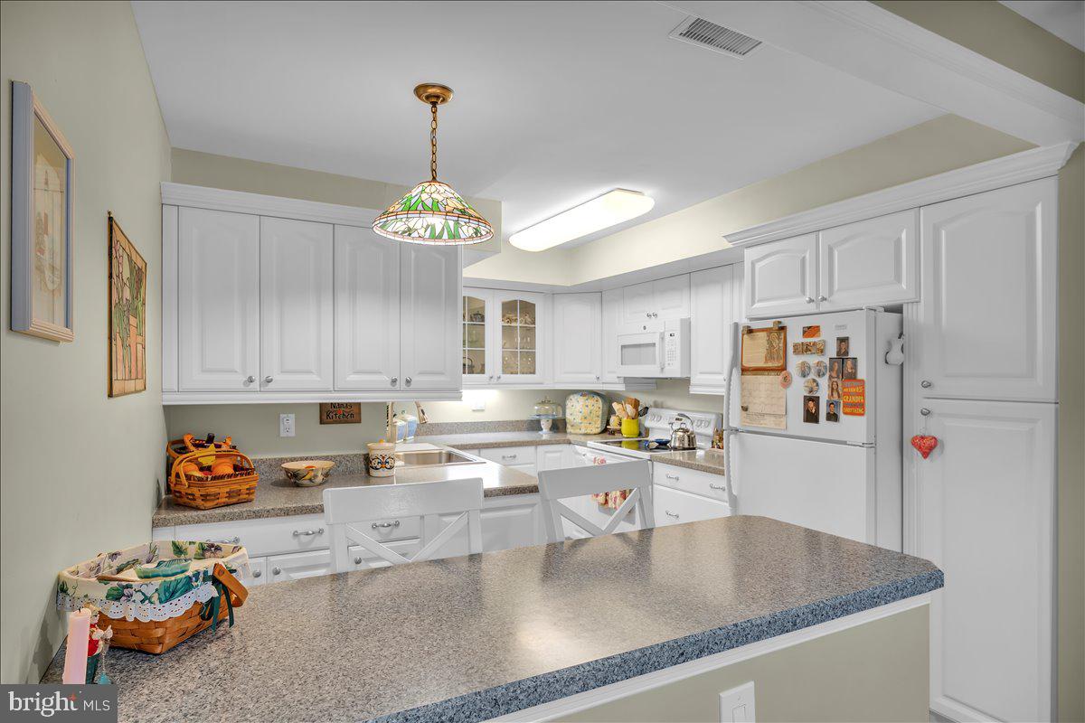 115 East Kings Highway, Unit 443 Maple Shade, NJ 08052 - Photo 11 of 24 a kitchen with refrigerator and window