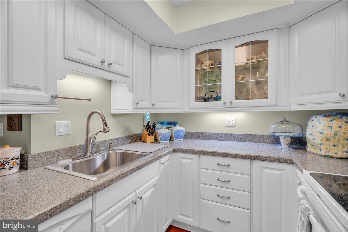 115 East Kings Highway, Unit 443 Maple Shade, NJ 08052 - Photo 14 of 24 a kitchen with granite countertop white cabinets and sink