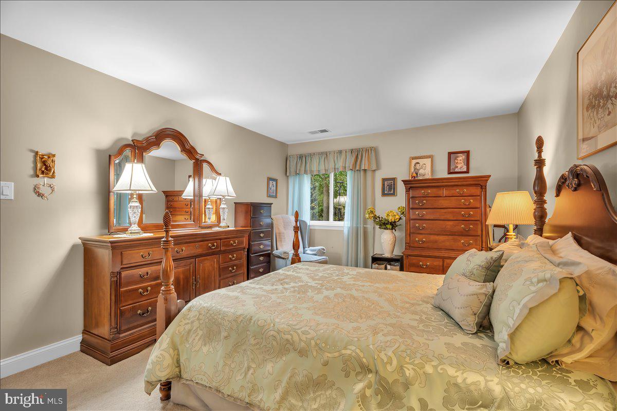 115 East Kings Highway, Unit 443 Maple Shade, NJ 08052 - Photo 18 of 24 a bedroom with a bed and a dresser