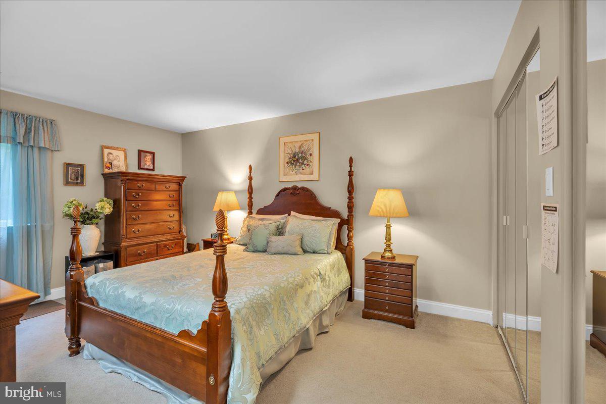 115 East Kings Highway, Unit 443 Maple Shade, NJ 08052 - Photo 19 of 24 a bedroom with a bed and a lamp