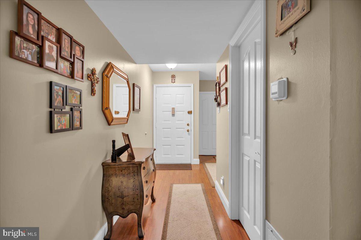 115 East Kings Highway, Unit 443 Maple Shade, NJ 08052 - Photo 4 of 24 a view of a hallway with entryway wooden floor and front door