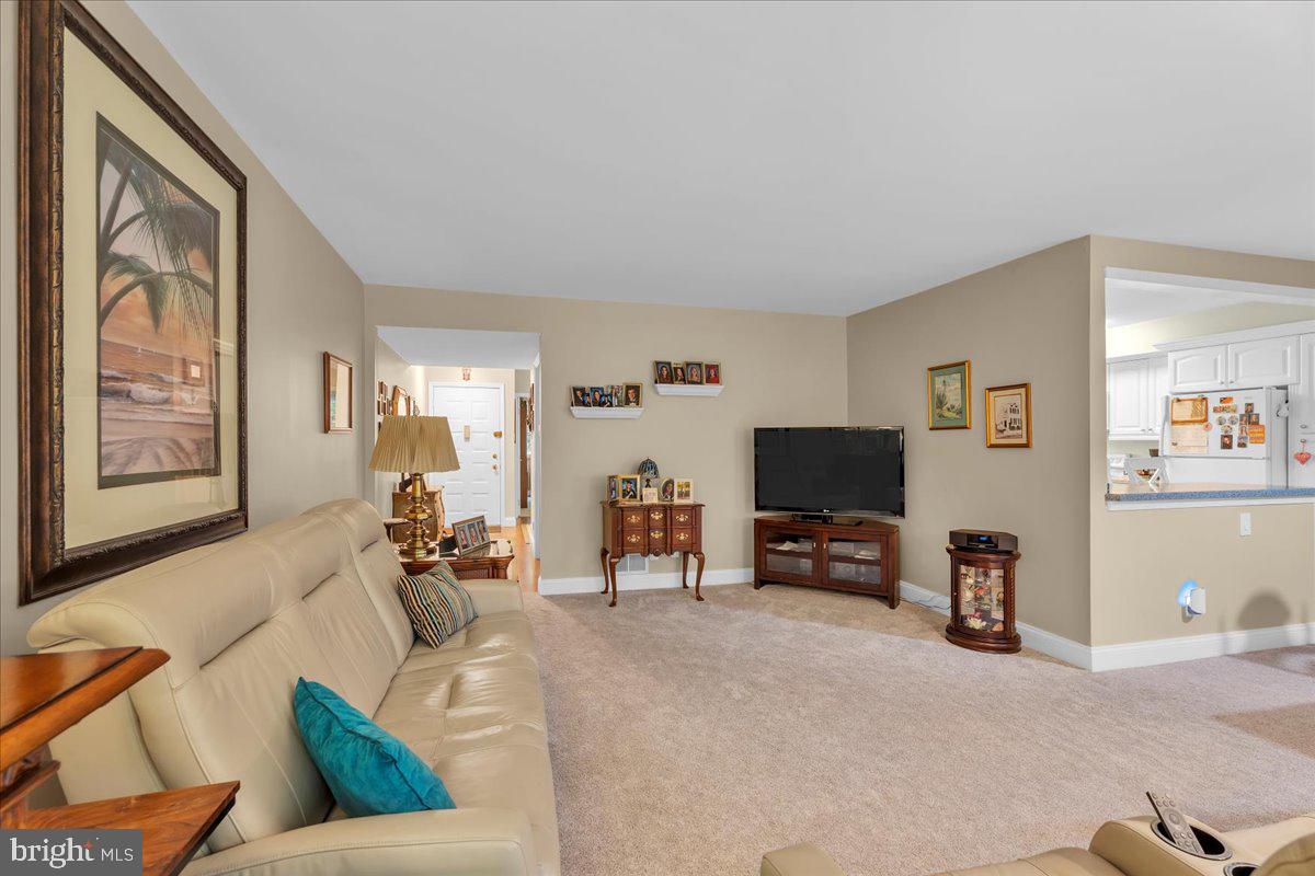 115 East Kings Highway, Unit 443 Maple Shade, NJ 08052 - Photo 6 of 24 a living room with furniture and a flat screen tv