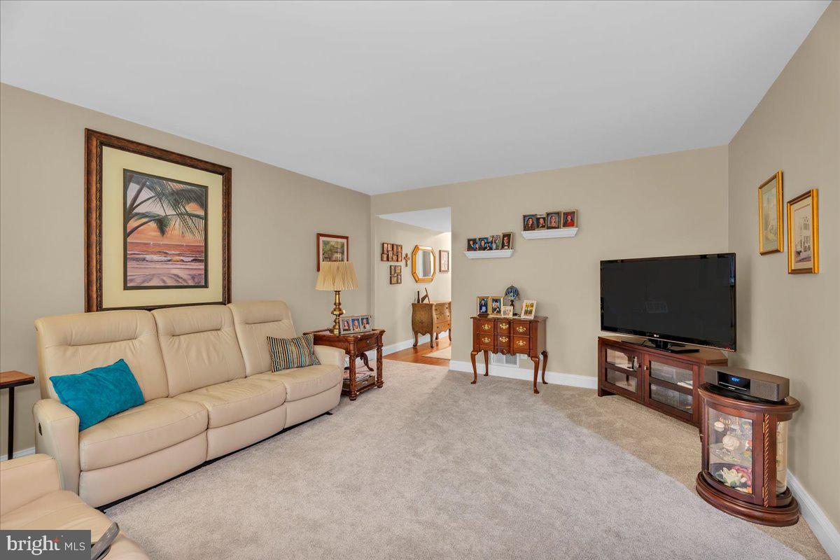 115 East Kings Highway, Unit 443 Maple Shade, NJ 08052 - Photo 7 of 24 a living room with furniture and a flat screen tv