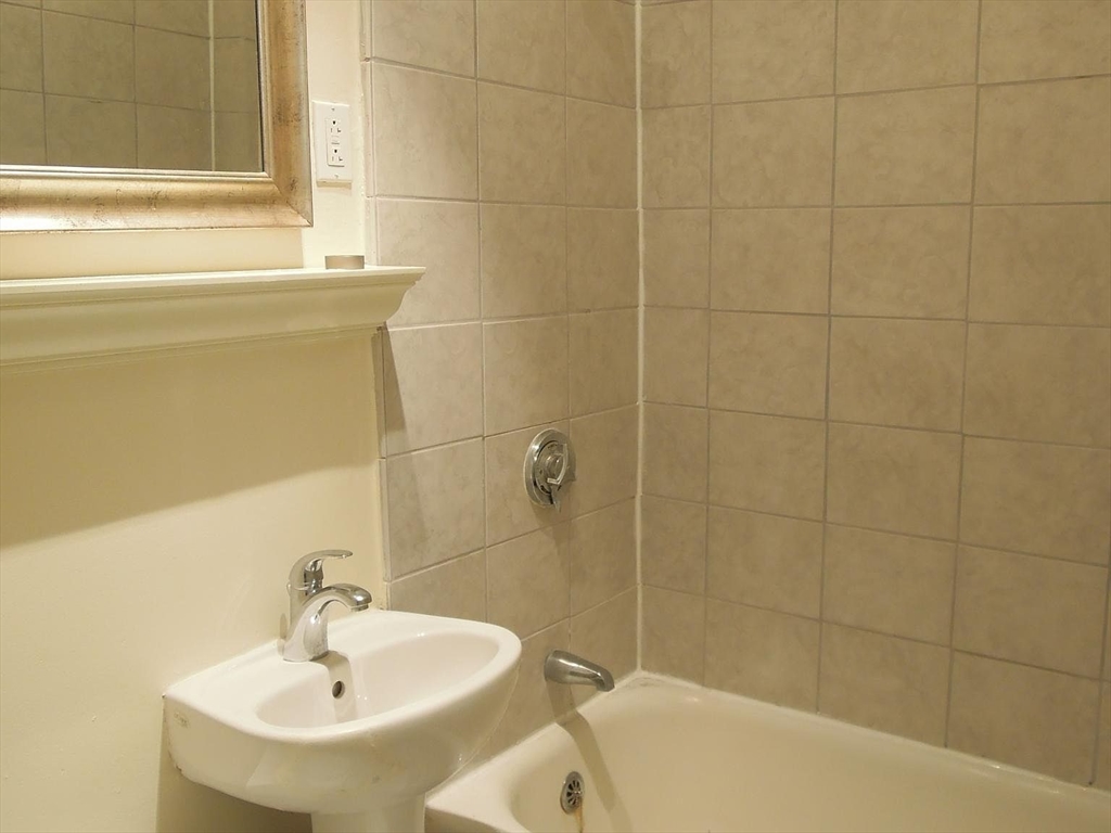 8 Garrison Street, Unit 209 Boston, MA 02116 - Photo 14 of 33 a bathroom with a sink and a bathtub