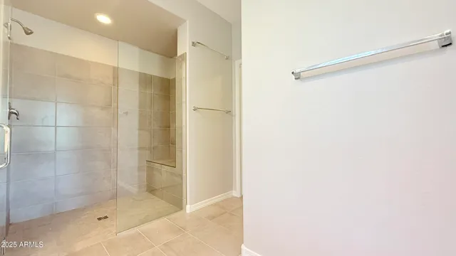 a bathroom with a shower and a glass door