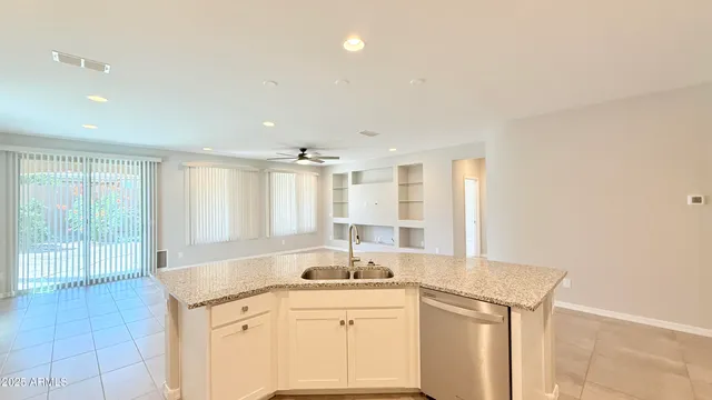 a view of a sink and dishwasher with wooden floor