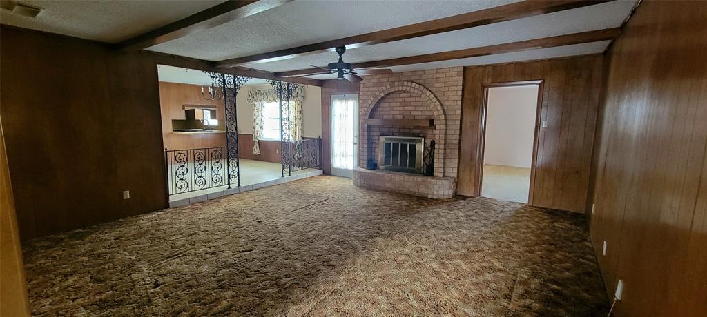 7813 Pebbleford Road Fort Worth, TX 76134 - Photo 3 of 23 a view of a hallway with wooden floor and a fireplace