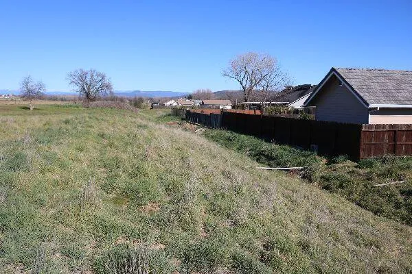 a view of a large body of water with a building in the background