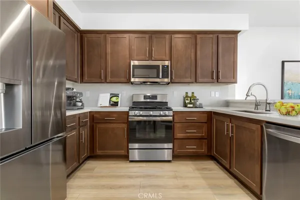 a kitchen with a sink and steel stainless steel appliances