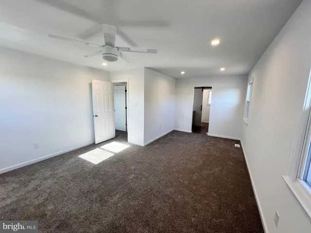 an empty room with windows and entrance