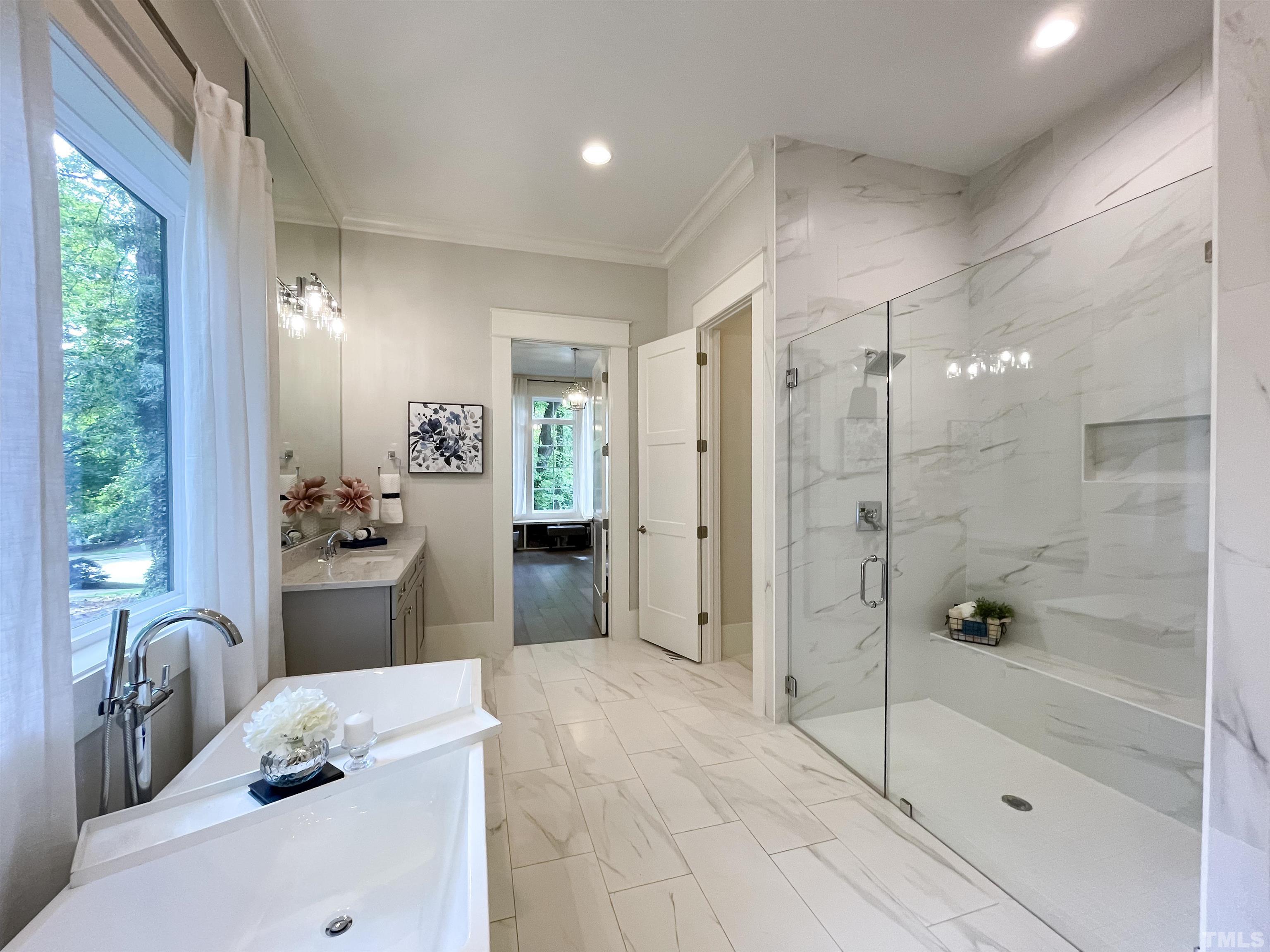 7824 Harps Mill Road Raleigh, NC 27615 - Photo 11 of 17 a bathroom with a tub sink mirror and shower