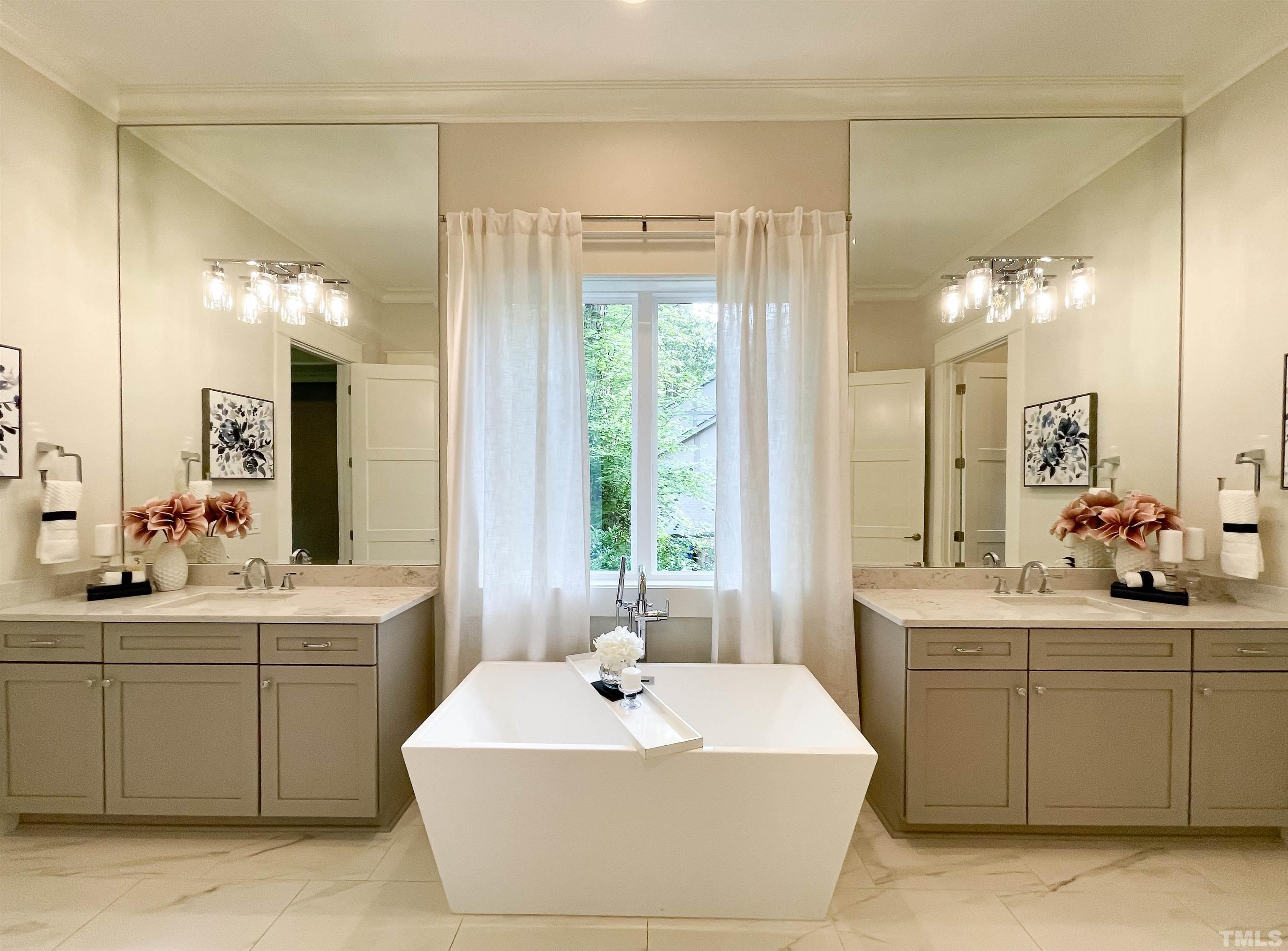 7824 Harps Mill Road Raleigh, NC 27615 - Photo 12 of 17 a spacious bathroom with a sink a large mirror and a bathtub