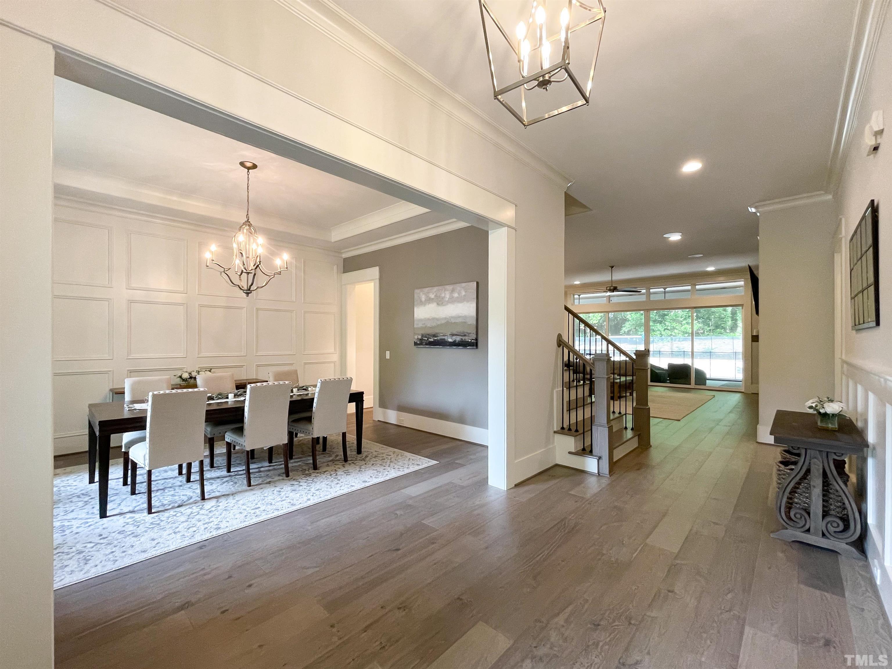 7824 Harps Mill Road Raleigh, NC 27615 - Photo 3 of 17 a view of a dining room with furniture window and wooden floor
