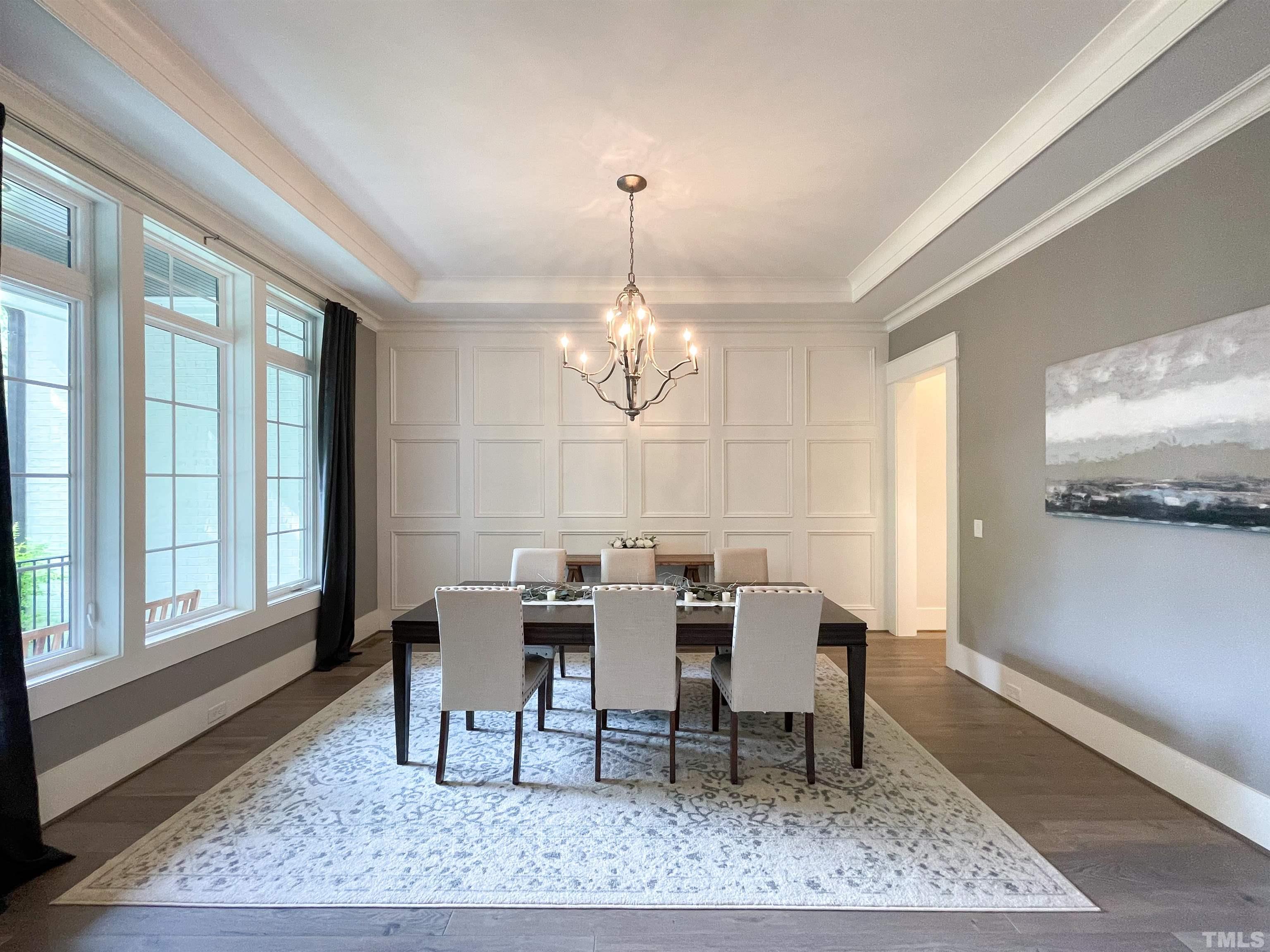 7824 Harps Mill Road Raleigh, NC 27615 - Photo 4 of 17 a view of a dining room with furniture window and wooden floor