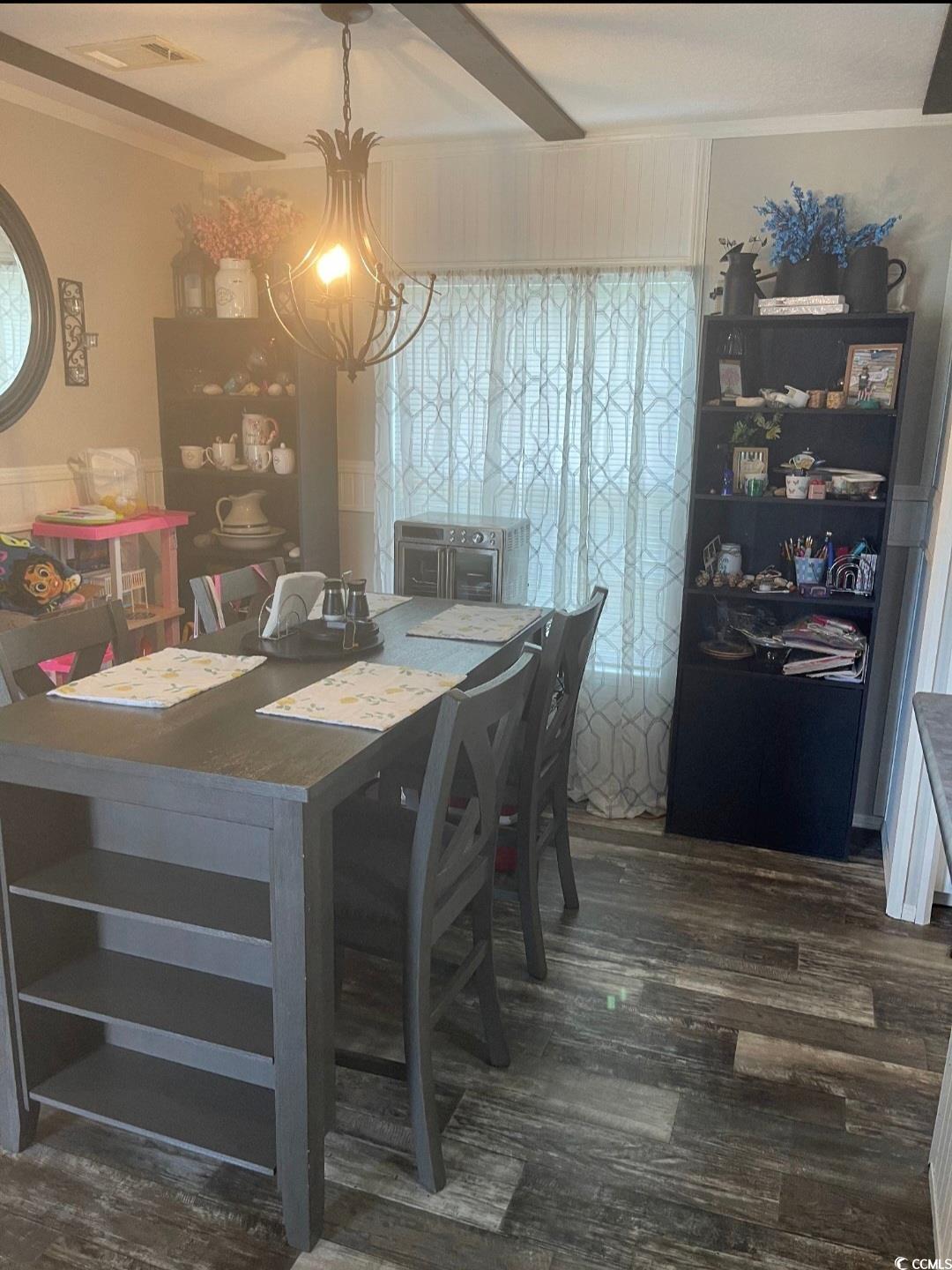 2470 Wigley Road Loris, SC 29569 - Photo 12 of 30 Dining area with dark wood-type flooring, beamed ceiling, and ornamental molding