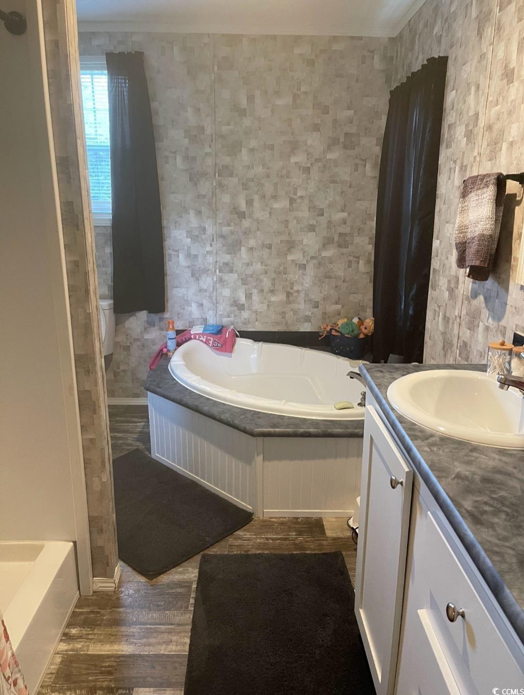 2470 Wigley Road Loris, SC 29569 - Photo 20 of 30 Full bathroom with a garden tub, vanity, and dark wood-style floors