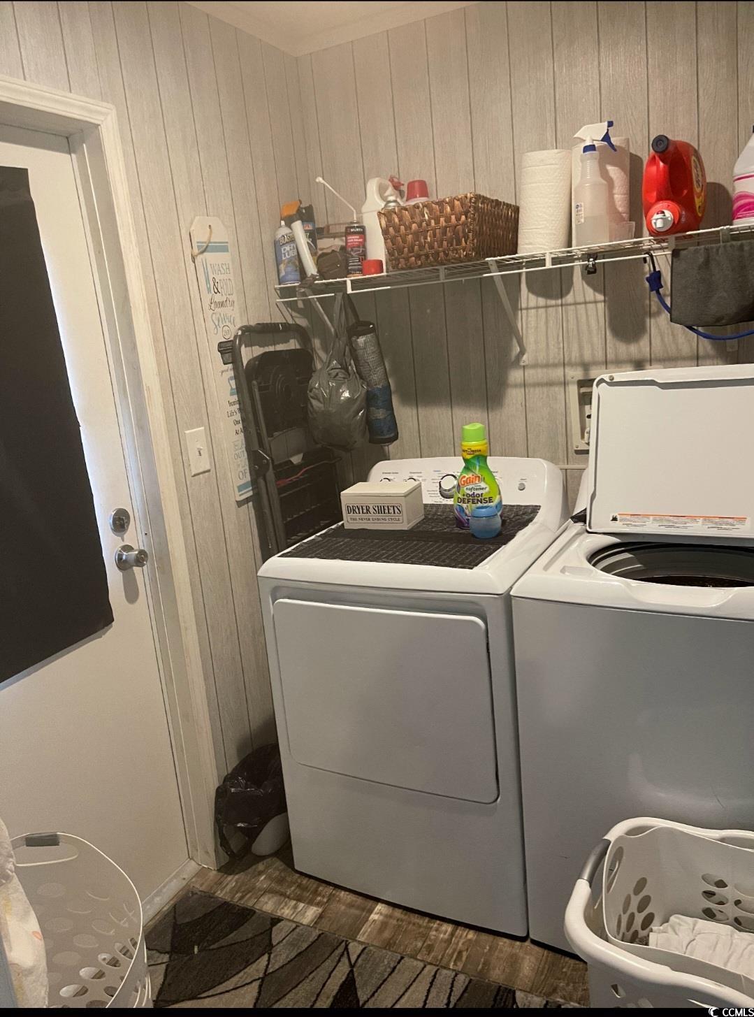 2470 Wigley Road Loris, SC 29569 - Photo 26 of 30 Laundry room with washer and clothes dryer and wood walls