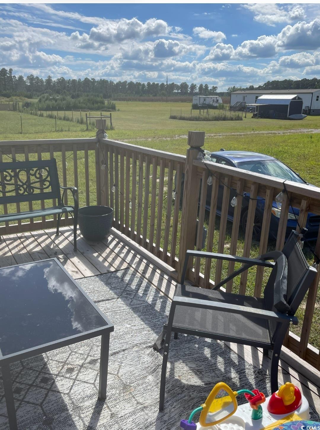 2470 Wigley Road Loris, SC 29569 - Photo 4 of 30 Wooden terrace featuring a view of rural / pastoral area and a yard