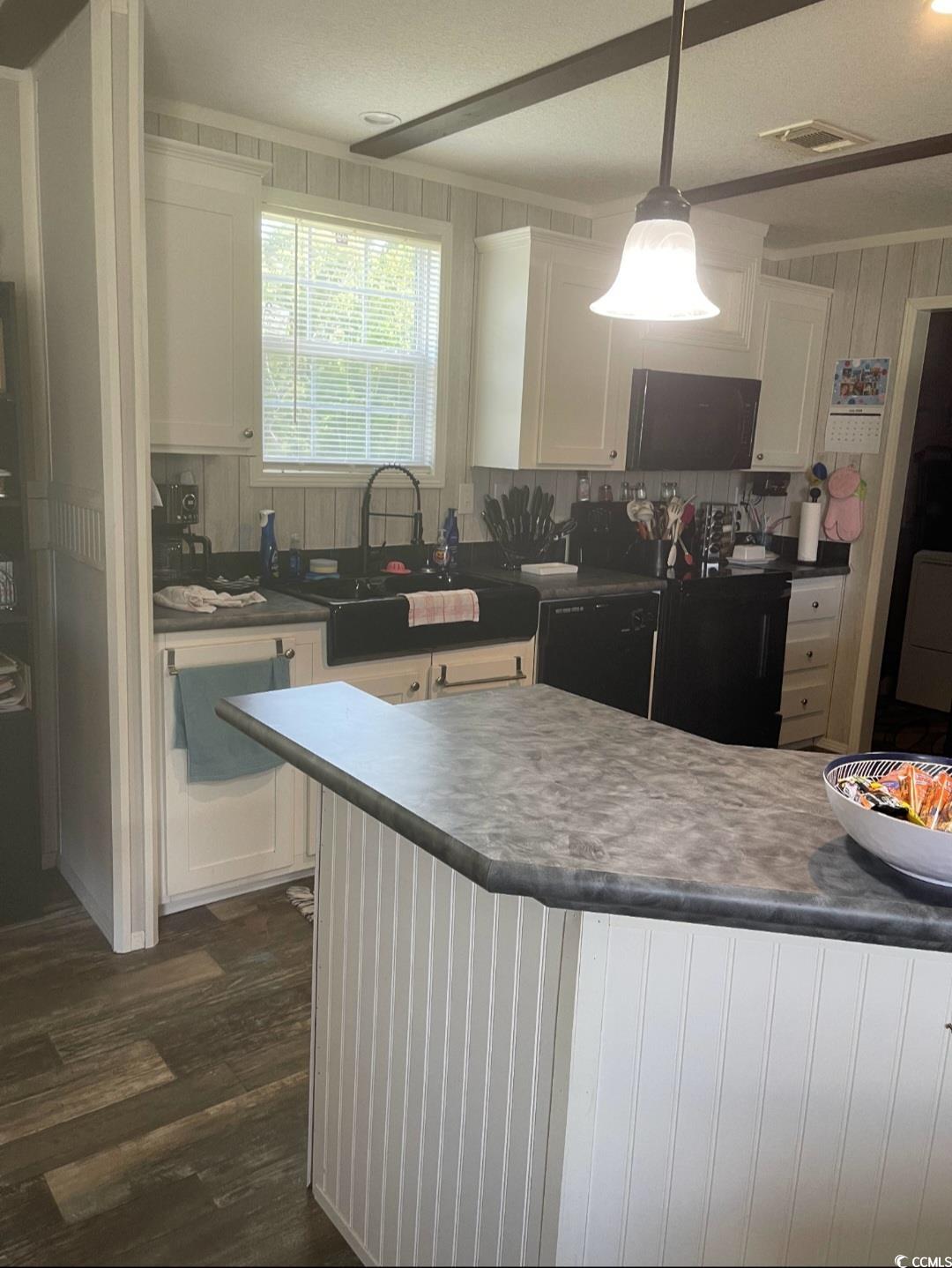 2470 Wigley Road Loris, SC 29569 - Photo 5 of 30 Kitchen featuring white cabinets, dark countertops, black appliances, dark wood finished floors, and washer / dryer