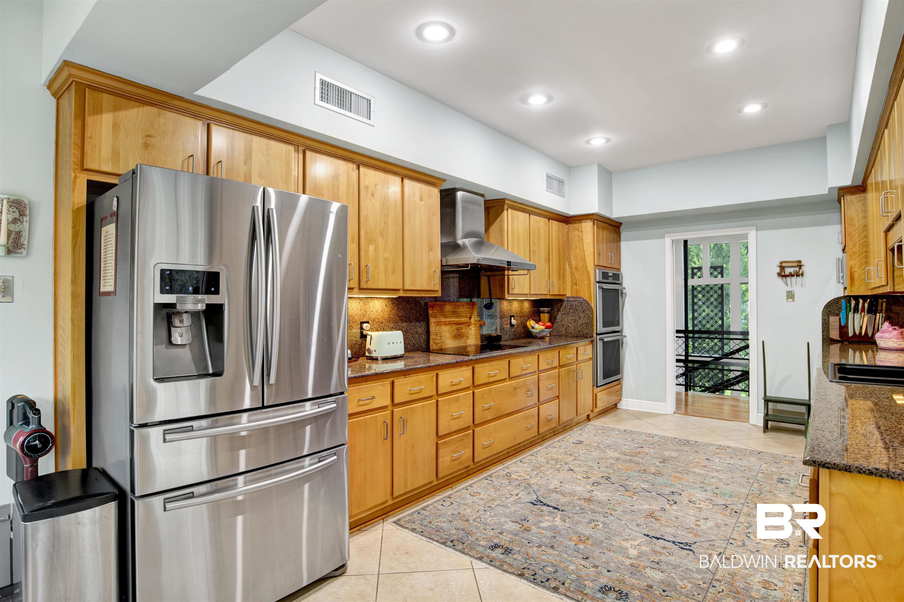 809 Bernard Circle Mobile, AL 36693 - Photo 32 of 75 Kitchen featuring extensive natural wood cabinetry, stainless steel appliances, granite countertops, and recessed lighting