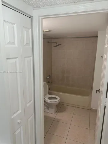 a bathroom with a granite countertop toilet a sink and shower
